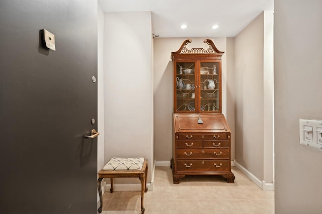 interior space featuring recessed lighting, baseboards, and light tile patterned floors