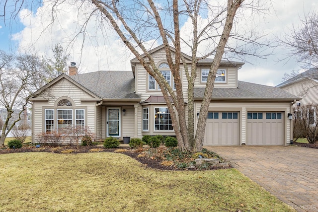 view of front facade with a garage and a front lawn