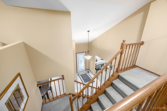 stairs with high vaulted ceiling