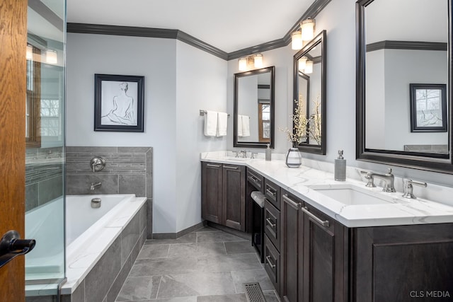 bathroom with vanity, tiled tub, and crown molding