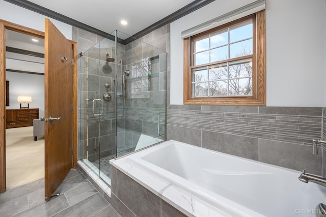 bathroom featuring tile patterned flooring and separate shower and tub