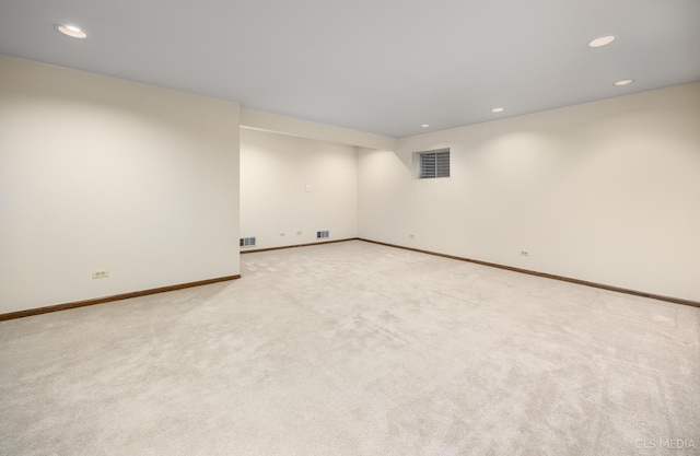 spare room featuring light colored carpet