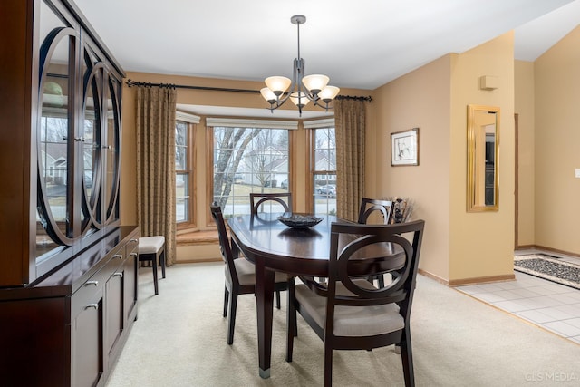 carpeted dining room with a chandelier