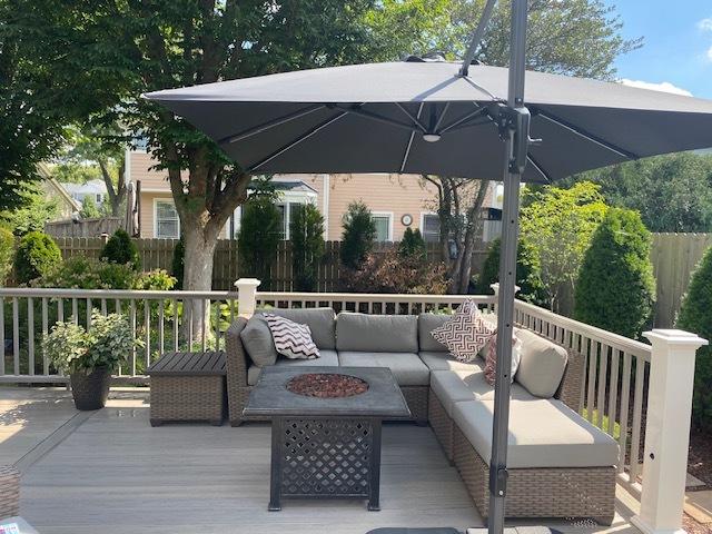 wooden deck featuring an outdoor living space with a fire pit