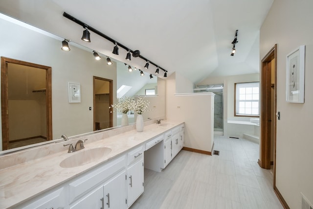 bathroom featuring a shower with door, vanity, and lofted ceiling