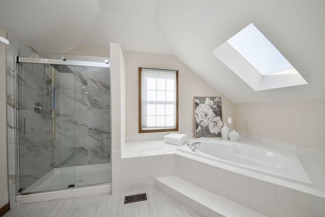 bathroom with shower with separate bathtub and vaulted ceiling with skylight