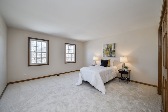 bedroom featuring light carpet