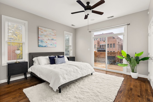 bedroom with ceiling fan, dark hardwood / wood-style flooring, multiple windows, and access to outside