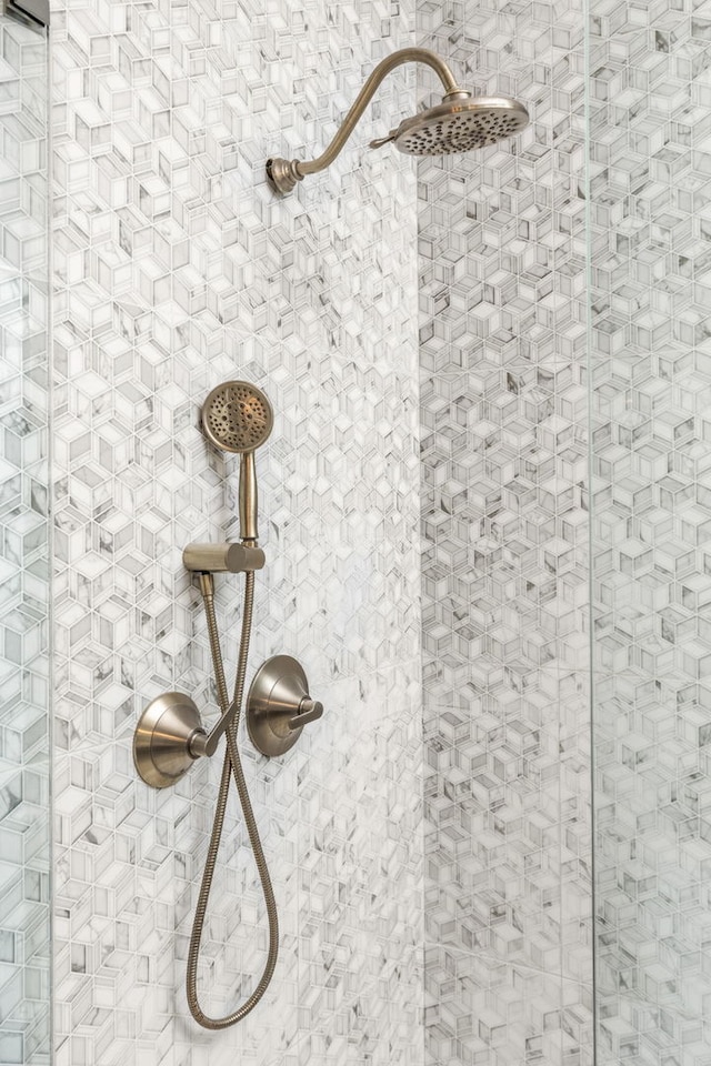 interior details with a tile shower