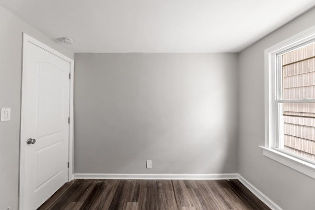 empty room featuring dark wood-type flooring