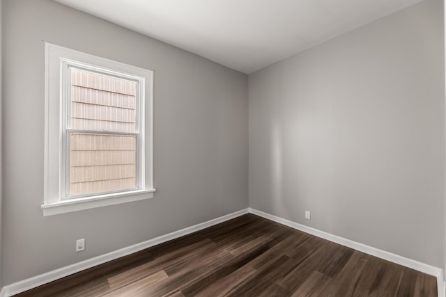 unfurnished room featuring dark wood-type flooring