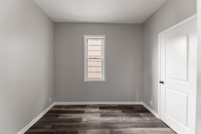 spare room with dark wood-type flooring