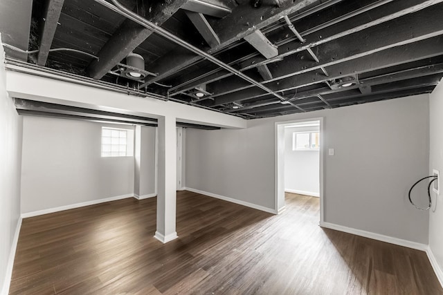 basement with dark hardwood / wood-style flooring