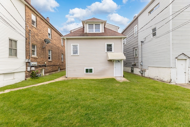 rear view of property with a lawn