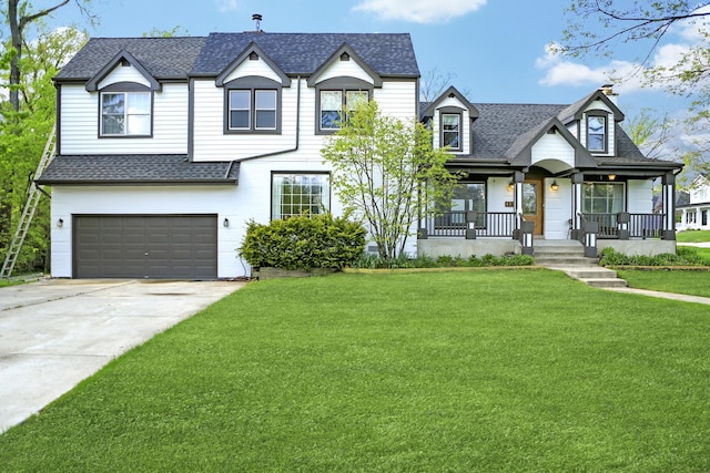 view of front facade with a porch, a garage, and a front yard