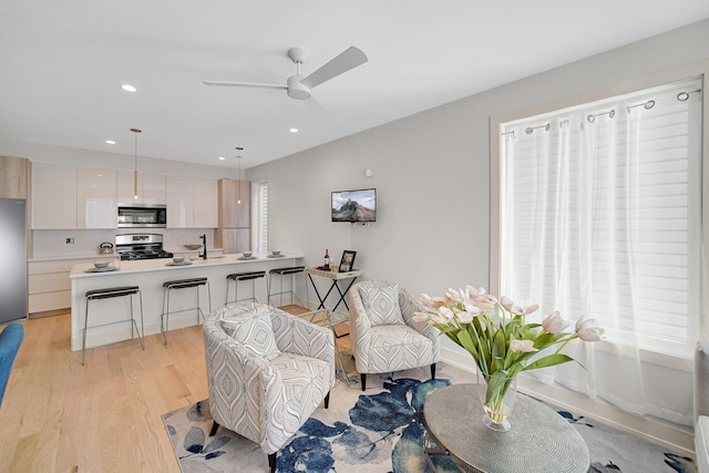 interior space with light hardwood / wood-style flooring and ceiling fan