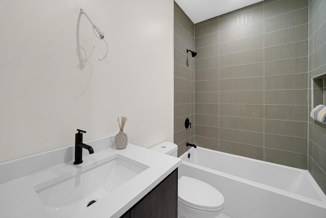 full bathroom with tiled shower / bath, vanity, and toilet