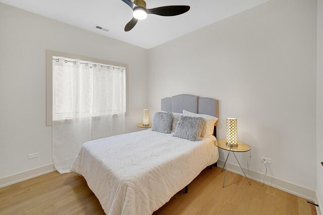 bedroom with hardwood / wood-style floors and ceiling fan