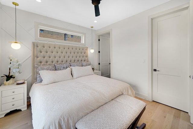 bedroom with light hardwood / wood-style floors and ceiling fan