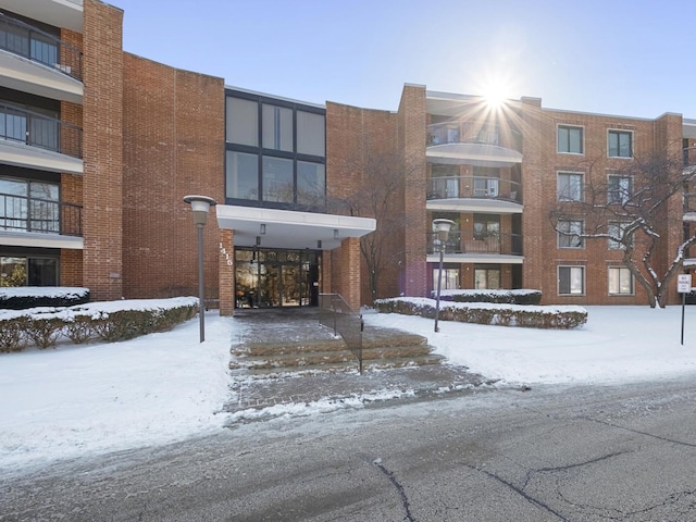 snow covered building with driveway