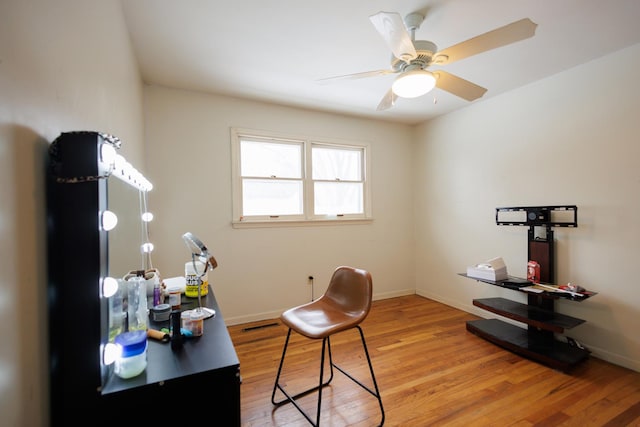 office with ceiling fan and light hardwood / wood-style flooring