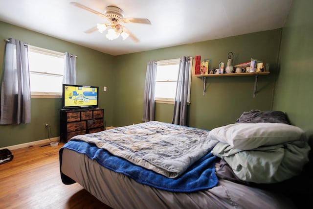 bedroom with ceiling fan and light wood-type flooring