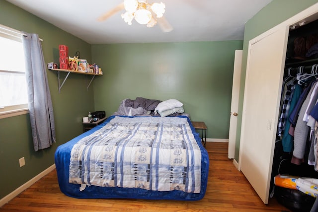 bedroom featuring wood-type flooring, a closet, and ceiling fan