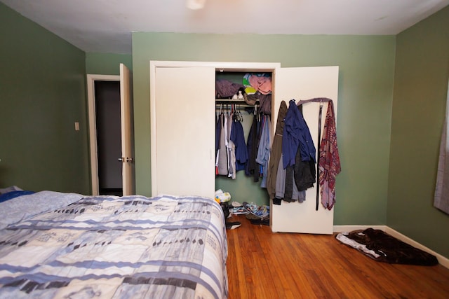 bedroom with hardwood / wood-style flooring and a closet