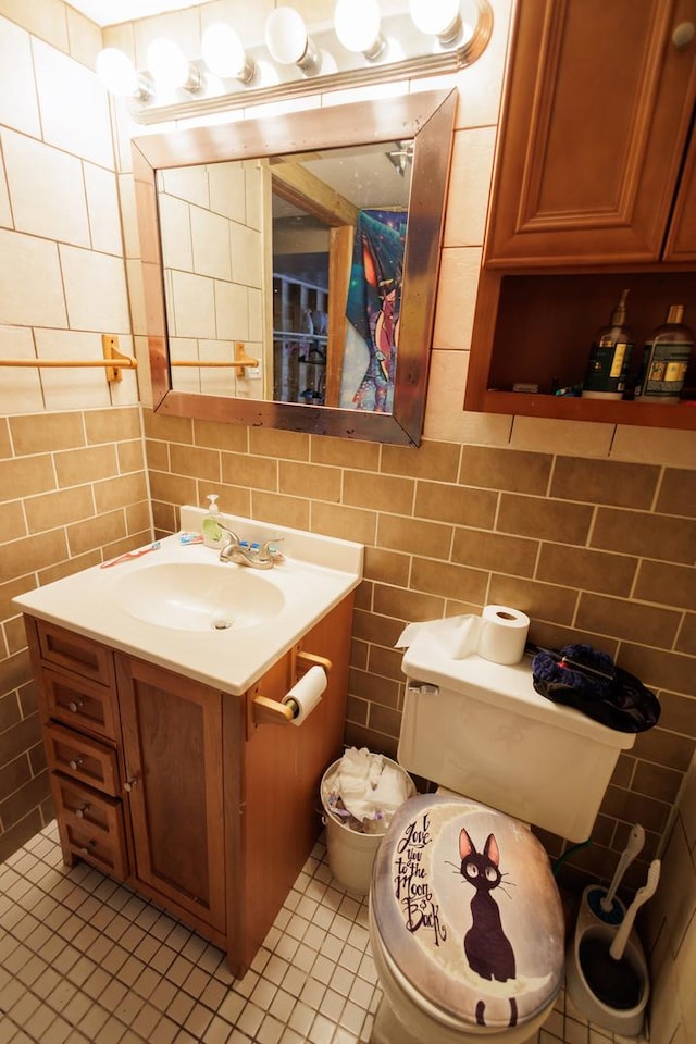 bathroom with vanity, tile patterned floors, toilet, and tile walls