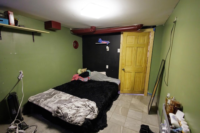 bedroom with light tile patterned floors