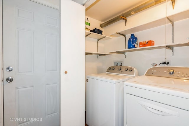 washroom featuring laundry area and washing machine and clothes dryer