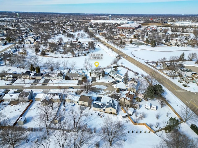 snowy aerial view with a residential view