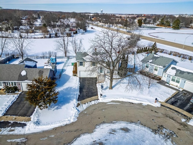 snowy aerial view featuring a residential view