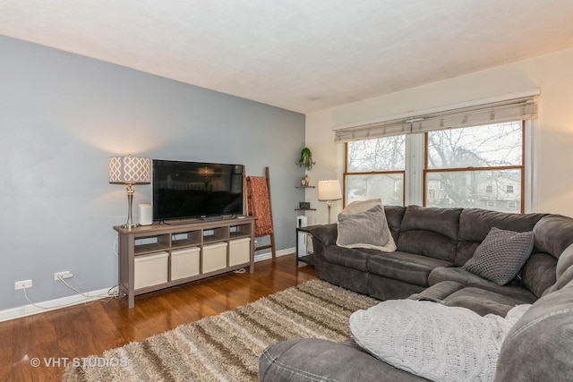 living area featuring baseboards and wood finished floors