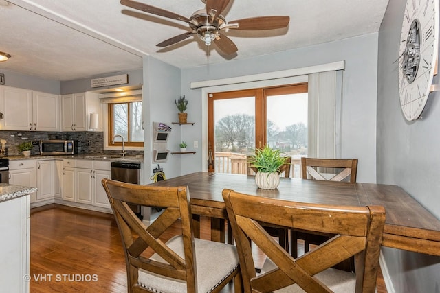 dining room with a ceiling fan, dark wood-style flooring, and a textured ceiling