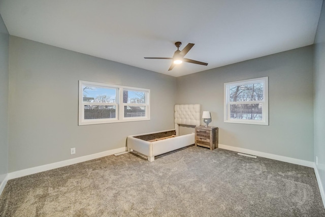 unfurnished room featuring ceiling fan and carpet