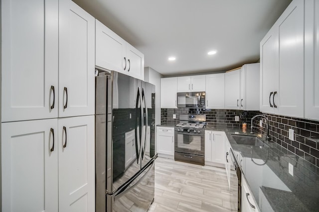 kitchen featuring sink, black appliances, and white cabinets