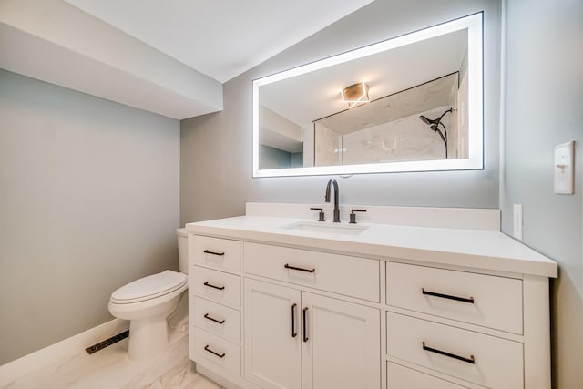 bathroom with vanity, lofted ceiling, toilet, and walk in shower