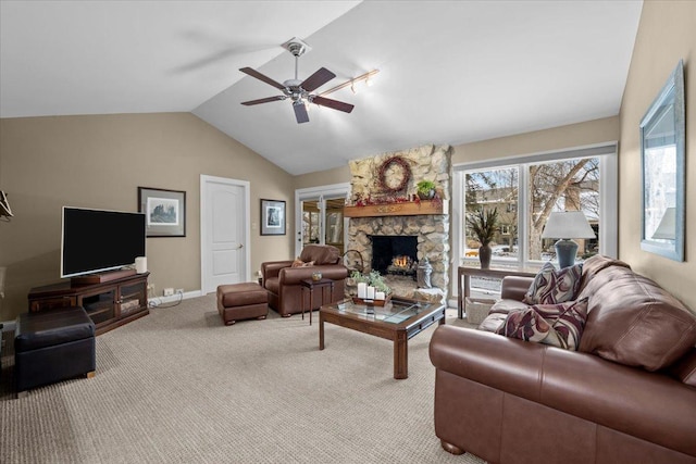 living room with light carpet, a stone fireplace, lofted ceiling, and ceiling fan