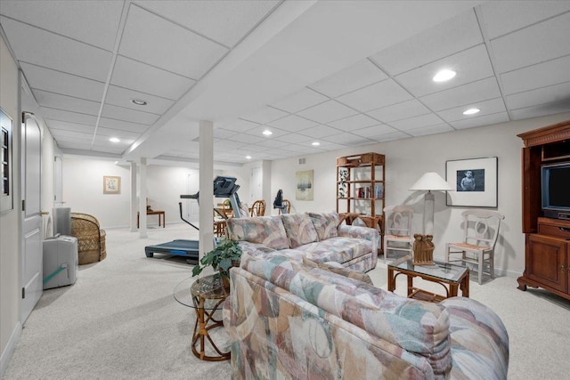 living room featuring carpet floors and a paneled ceiling