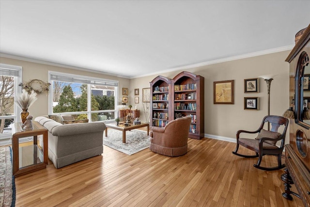 living room featuring ornamental molding and light hardwood / wood-style flooring