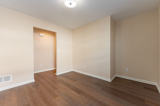 unfurnished room featuring dark wood-type flooring