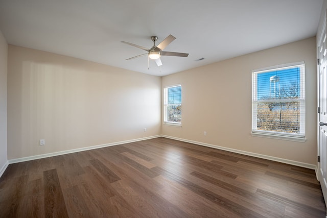 unfurnished room with dark hardwood / wood-style floors and ceiling fan