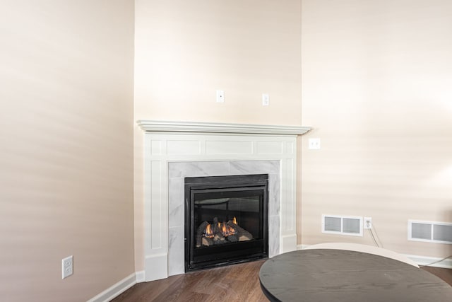 room details featuring hardwood / wood-style floors and a high end fireplace