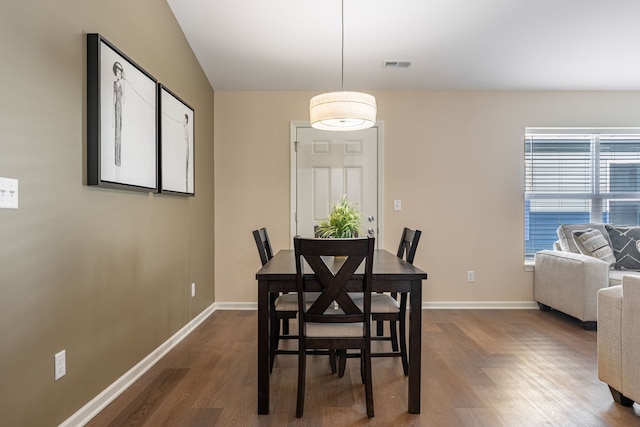 dining space with dark wood-type flooring