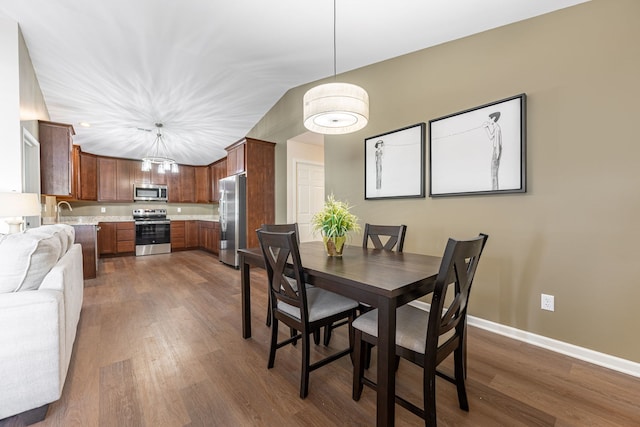 dining space featuring dark wood-type flooring and sink