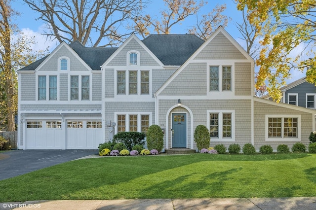 view of front facade featuring a garage and a front lawn