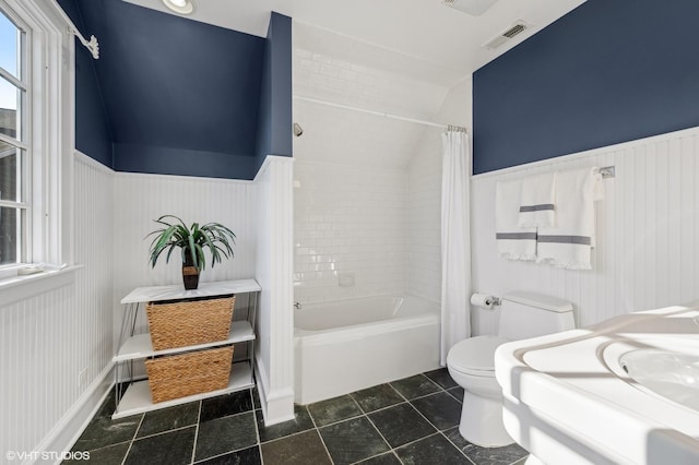 full bathroom with lofted ceiling, sink, shower / tub combo, tile patterned flooring, and toilet