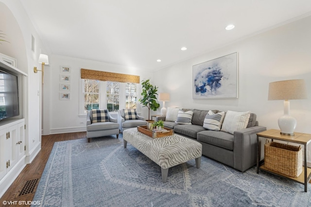 living room with ornamental molding and dark hardwood / wood-style floors