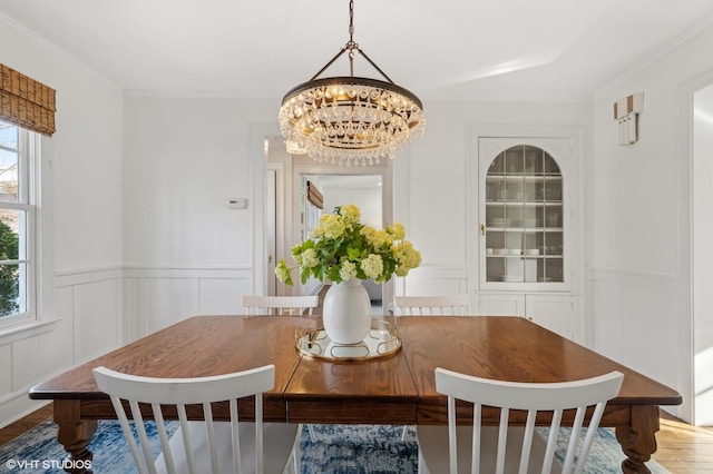 dining space featuring crown molding and a notable chandelier